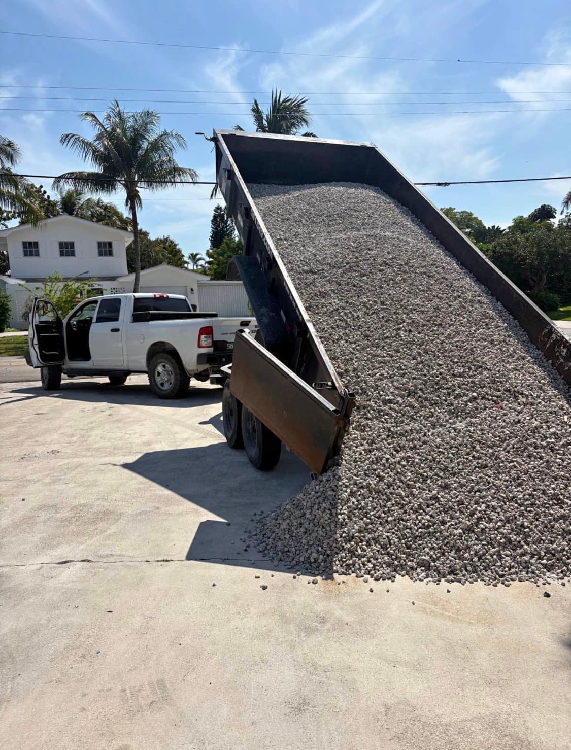 Trailer dumping crushed concrete millings on a driveway